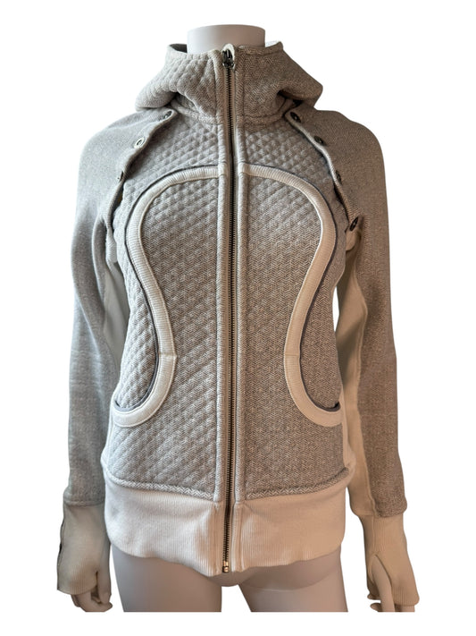 Two-tone jacket with quilted design on a mannequin against a white background