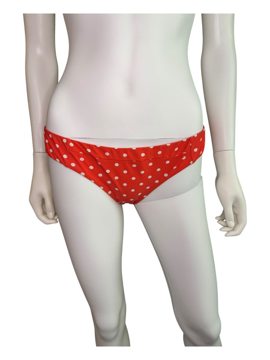Red polka dot bikini bottom on a mannequin against a white background